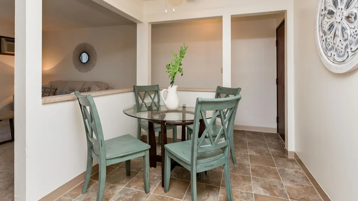 A dining room with a table and chairs