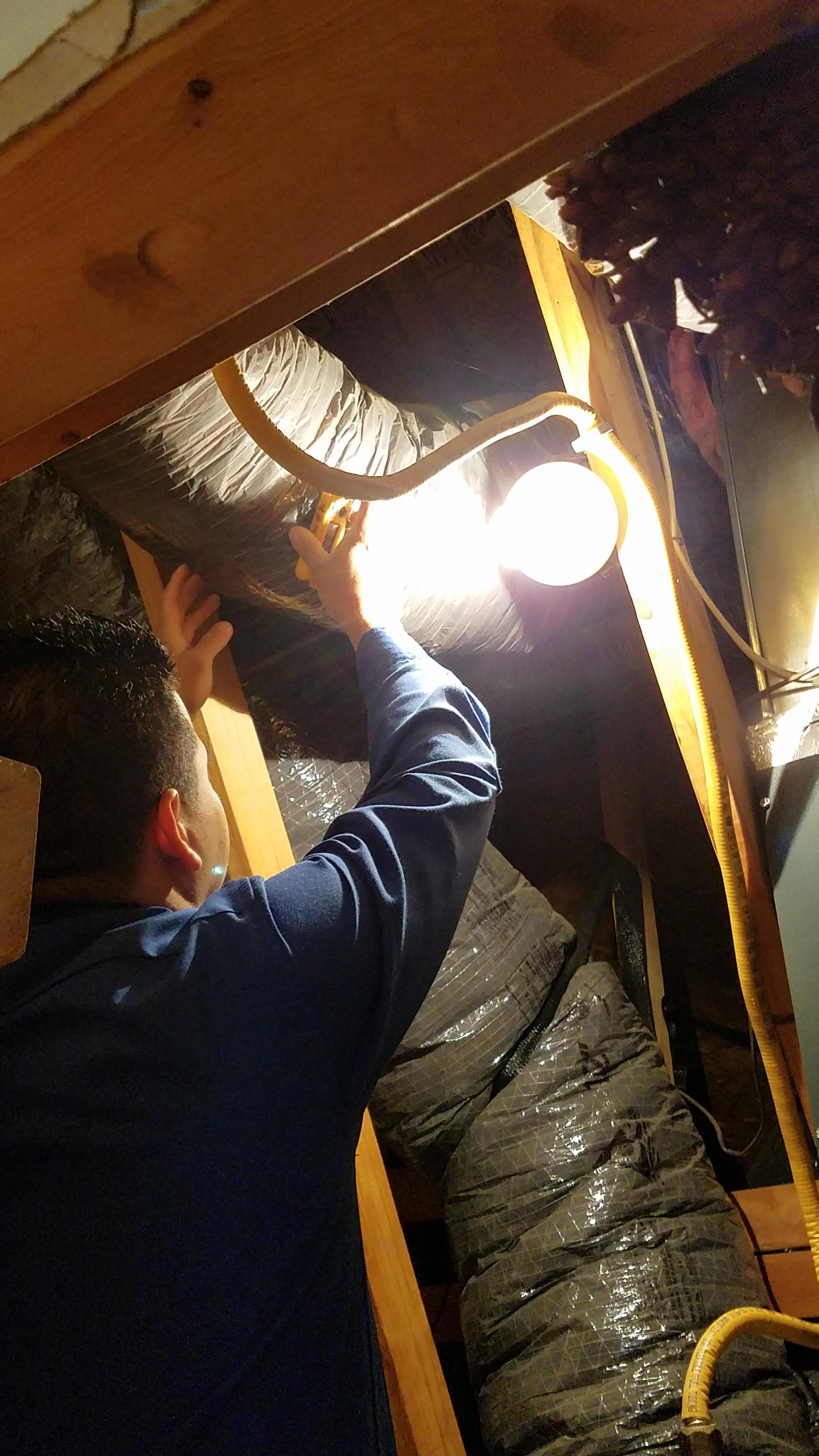 Garneski-Air-Conditioning-and-Heating-customer-inspecting-heating-system Garneski Air Conditioning & Heating Co Sterling (703)880-2770