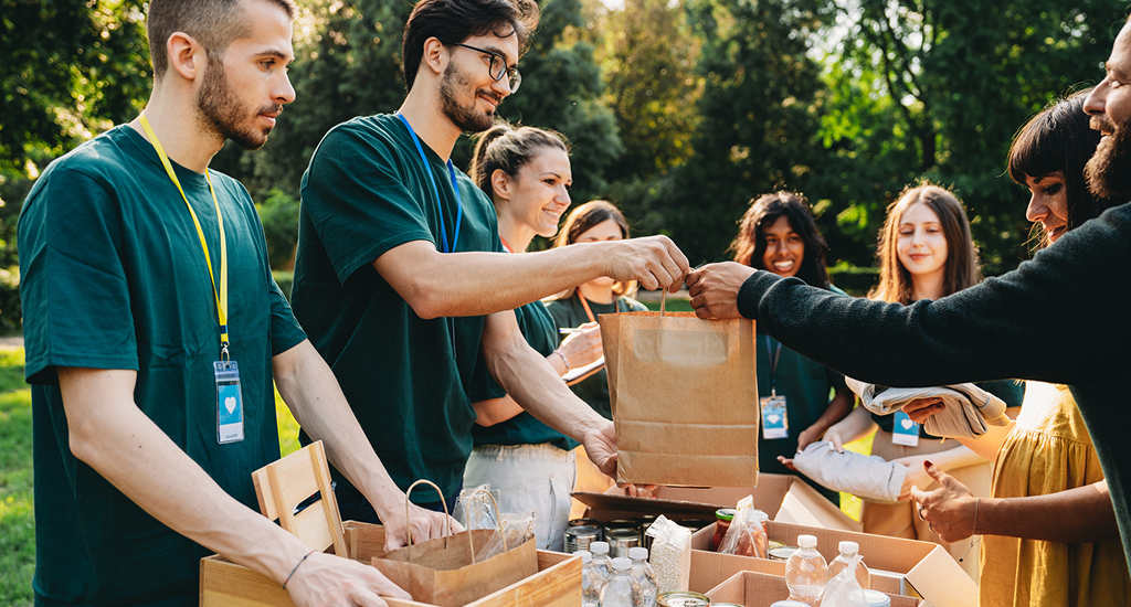 Volunteers handing out bags of food.
