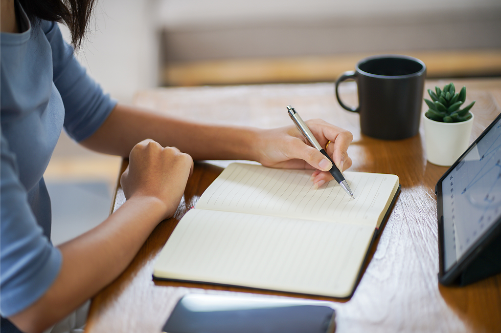 A person writing in a journal.