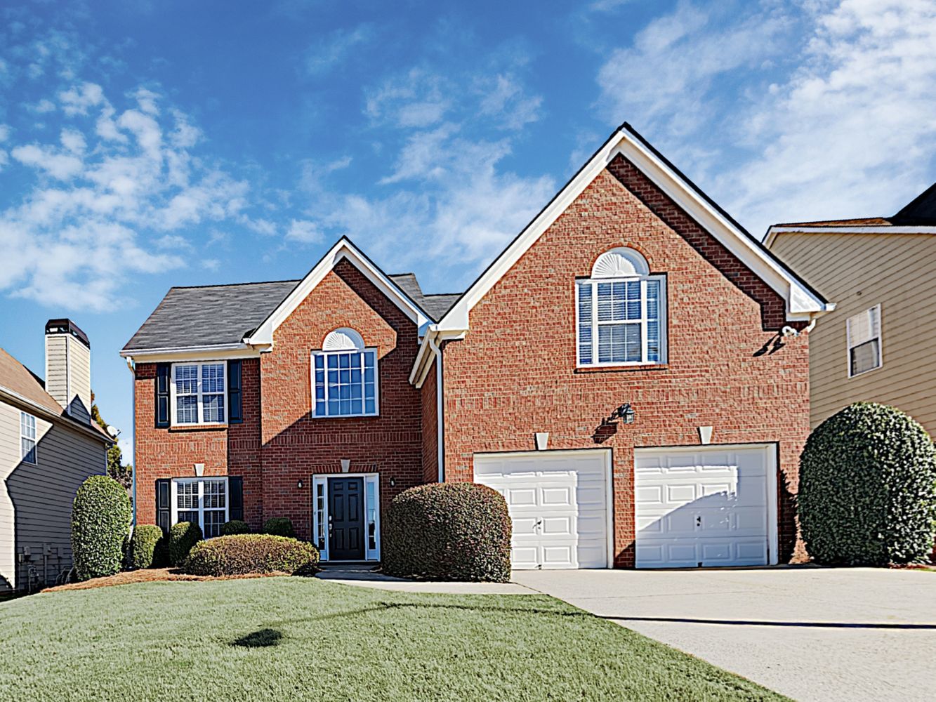 Lovely brick home with a two-car garage at Invitation Homes Atlanta.