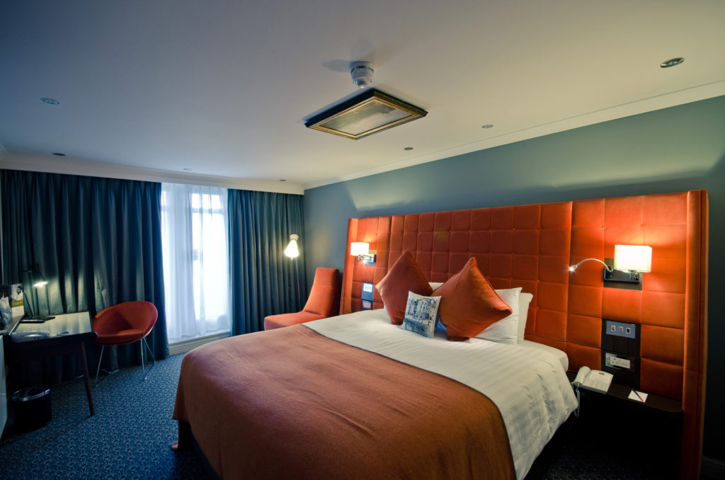 Privilege room, big comfy bed with orange headboard and bedspread Mercure Edinburgh City Princes Street Hotel Edinburgh 01313 421013