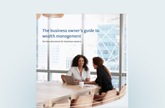 Cover of the business owner's guide with two professionals at a board room table.