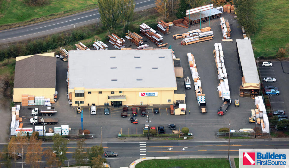 Building materials supplier Builders FirstSource's forklift is moving wood roof trusses.