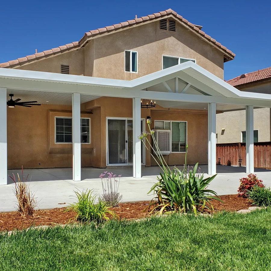 Alumawood patio cover with gabled roof line transforms the rear elevation of this home in Hemet..