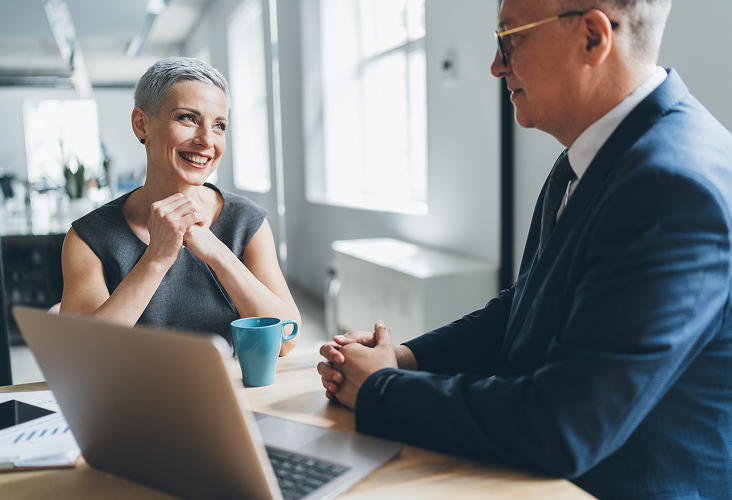 A wealth management professional speaking with a client.