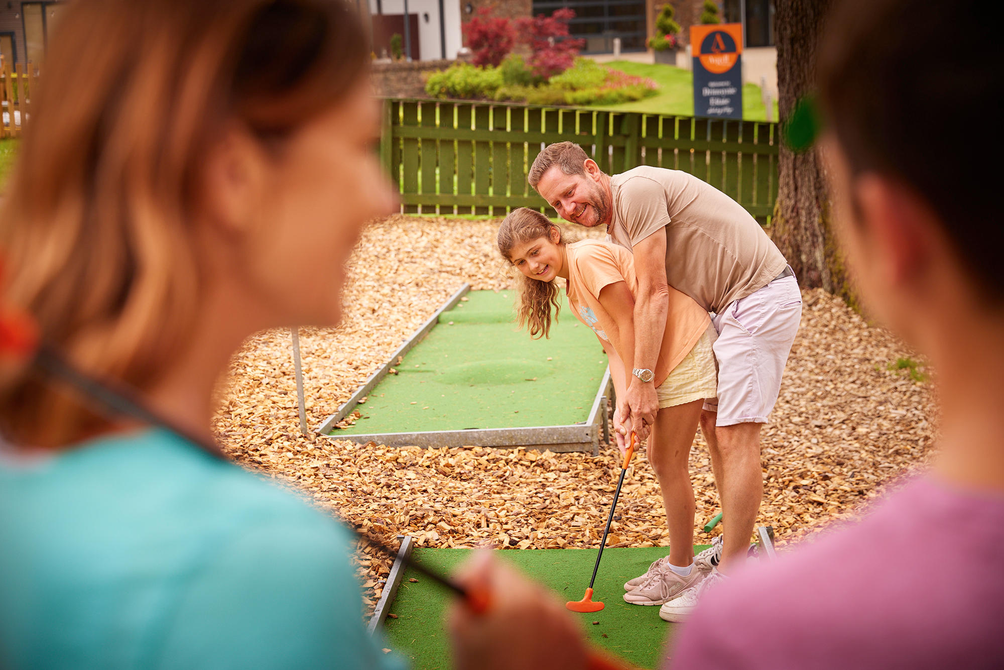 Family playing a game of Crazy Golf at Drimsynie Estate