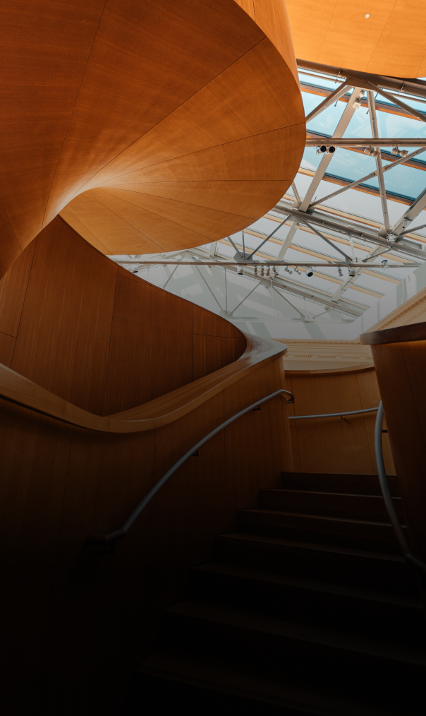 Upward view of the Frank Gehry spiral wooden staircase within the Art Gallery of Ontario.