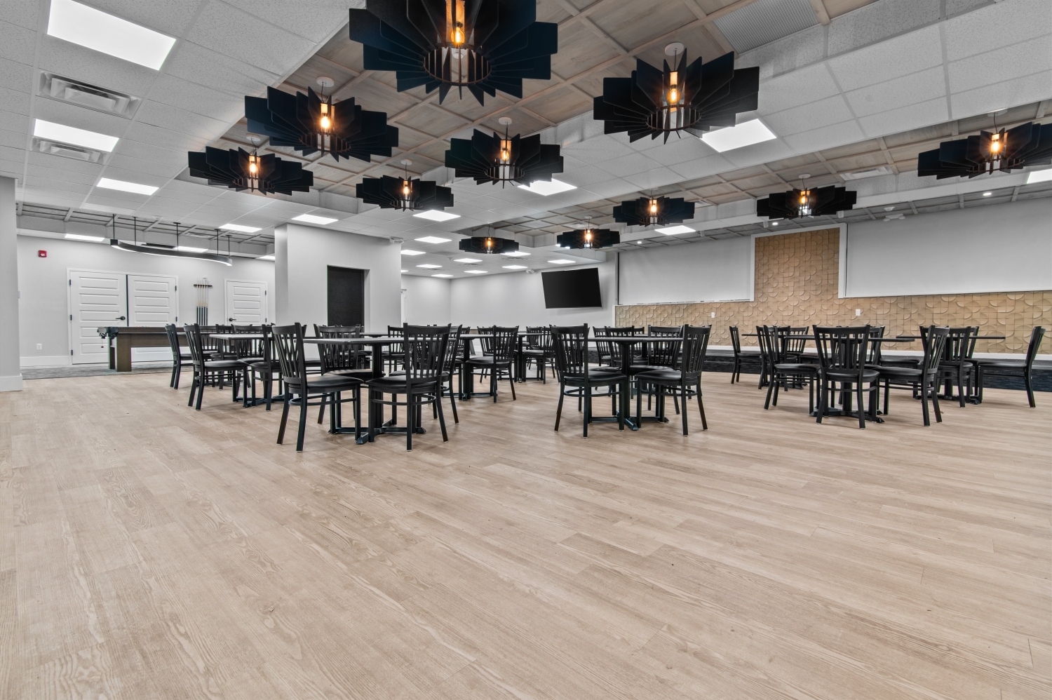 This spacious community activity and gathering room at Solaire Senior Living in Southfield, MI provides residents with a comfortable place to connect, relax, and participate in social events. Designed for adults 62 years of age and better, the open-concept space features modern lighting, stylish seating, and plenty of room for weekly activities, resident events, and community programs. As part of this luxury senior apartment community, the shared space supports an active and engaging lifestyle for residents who value comfort, connection, and convenience.