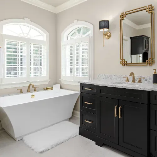 Custom bathroom renovation near Badin Lake, North Carolina with a modern black vanity, stone countertops, and clean tile work. This bathroom remodel demonstrates high-quality residential construction and attention to detail.