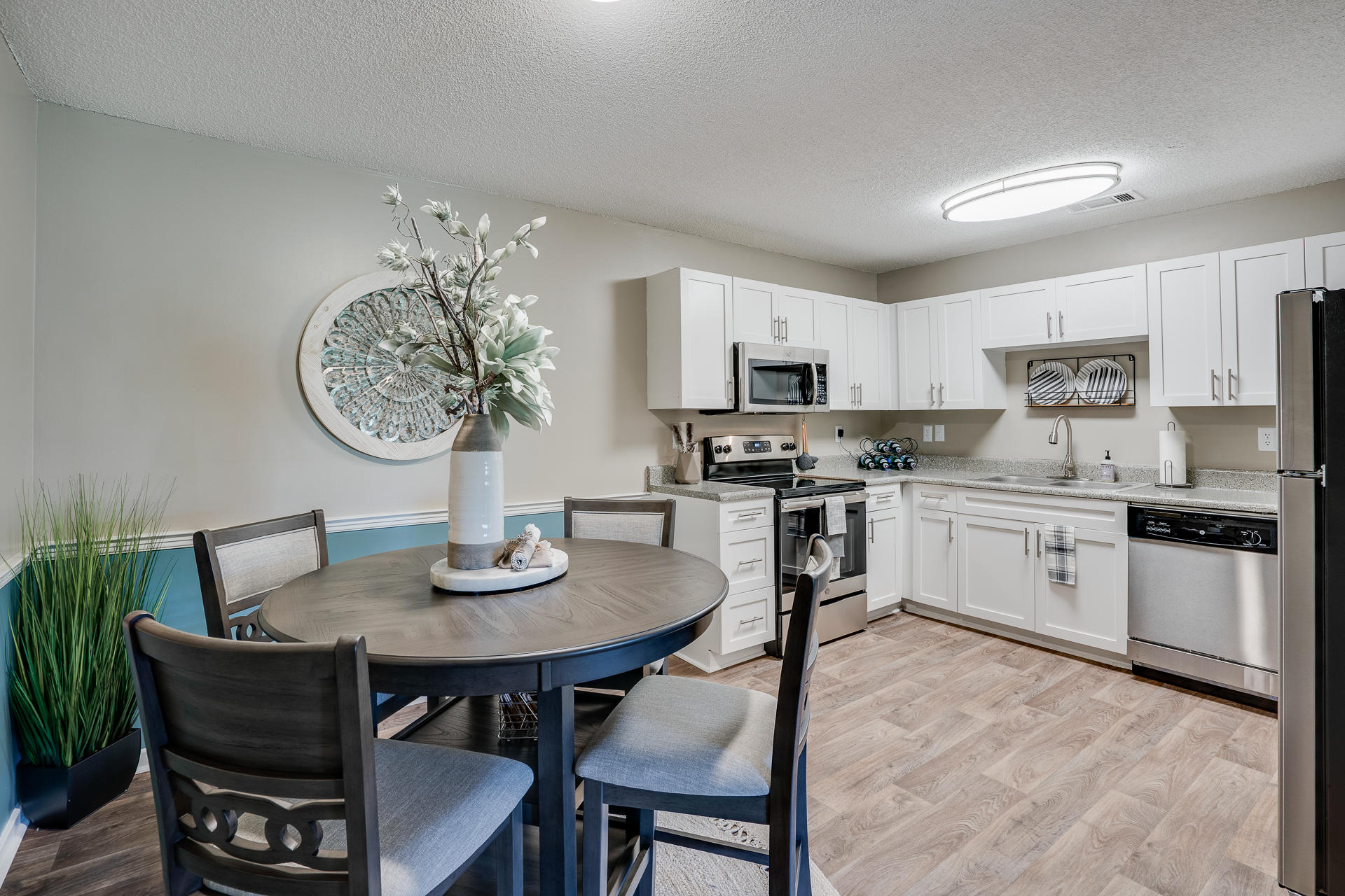 Open Concept Kitchen With Stainless Steel Appliances & Dining Area