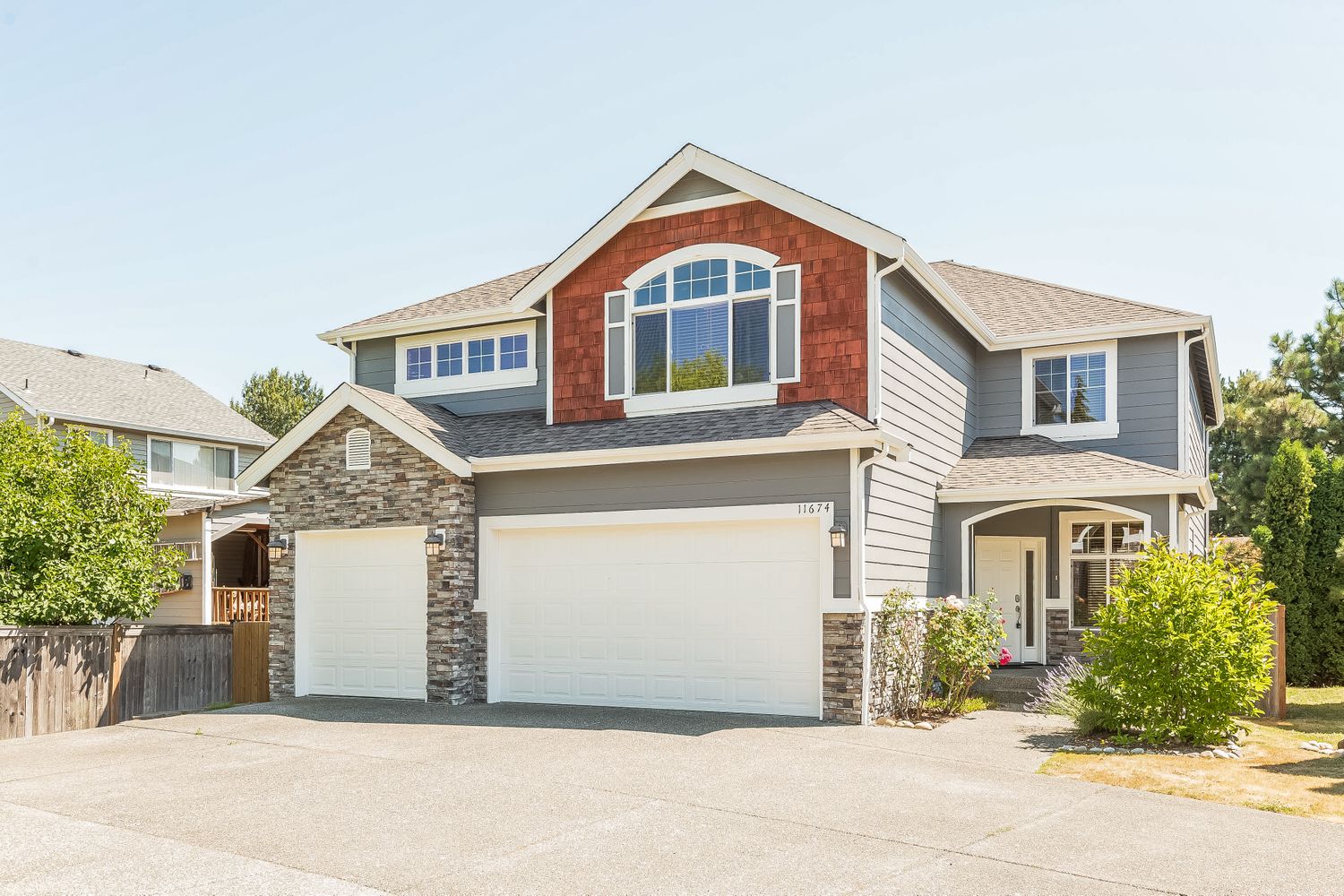 Unique three-car garage home with covered porch at Invitation Homes Seattle.