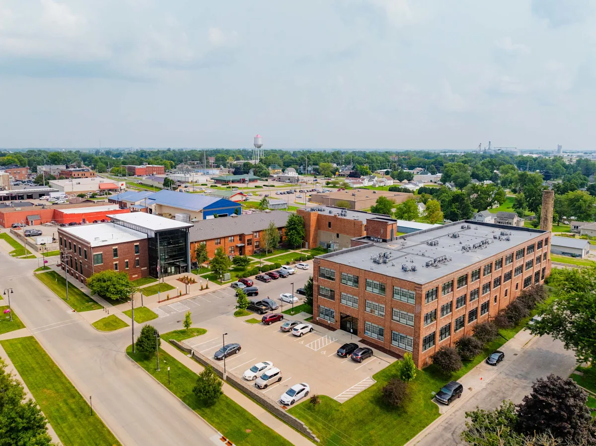 Drone view of Spaulding Lofts with parking