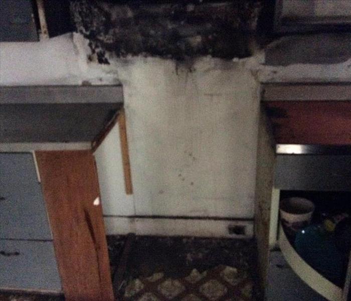 This kitchen fire was caused by the stove being left on and unattended. You can see above where the stove used to be located the burn marks against the wall of where the fire had started.
