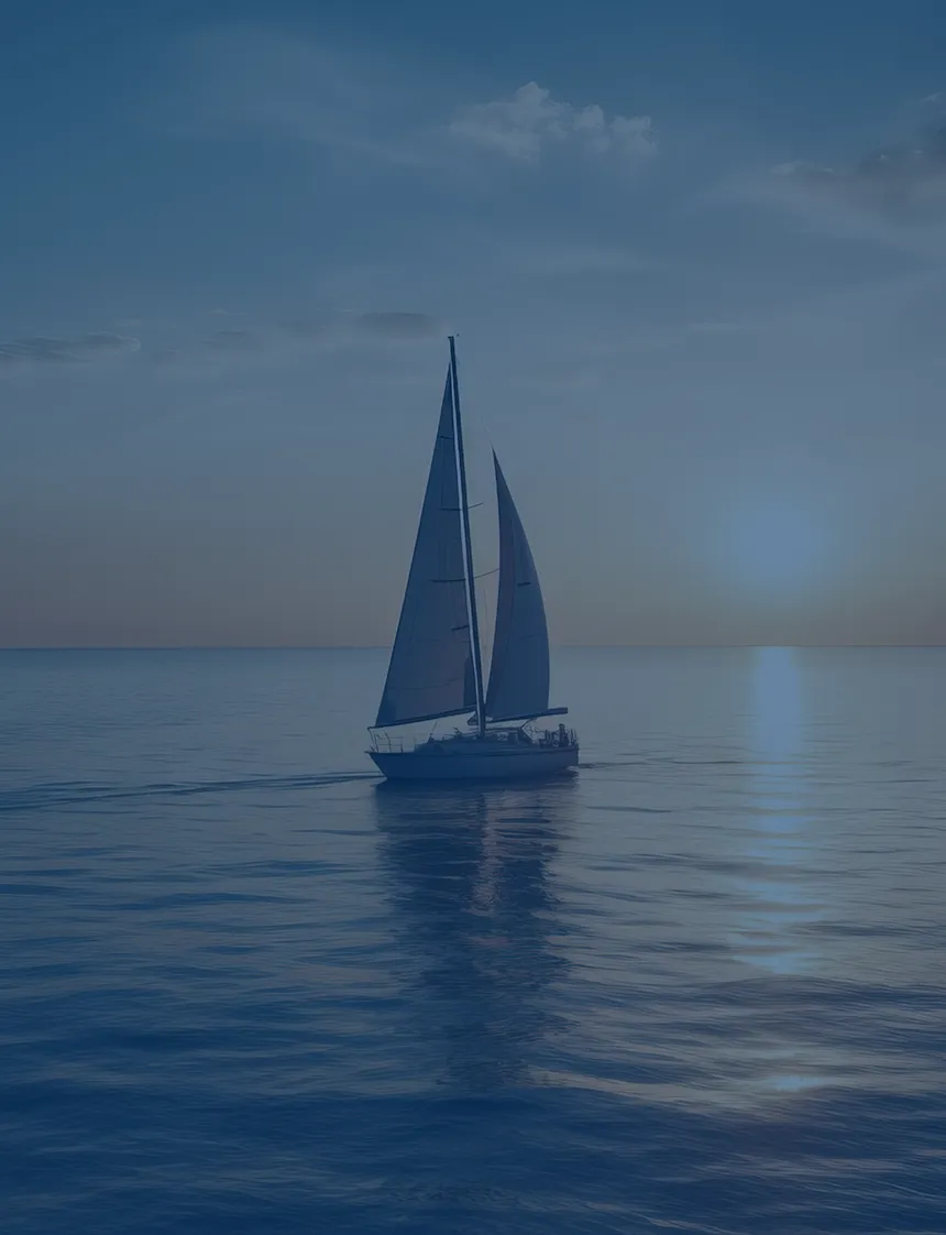 A sailboat gliding across calm open water toward a golden sunset on the horizon.
