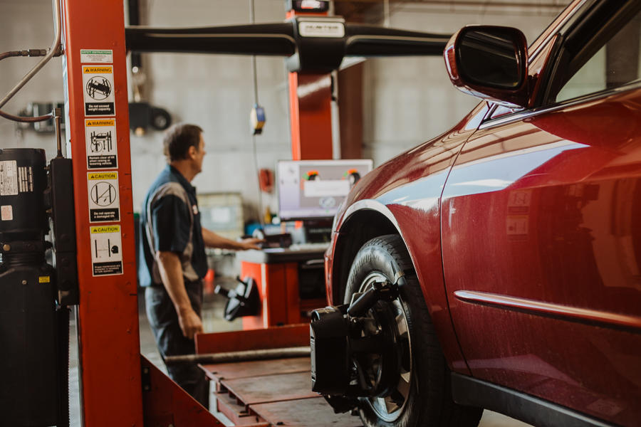 mechanic repairing vehicle alignment