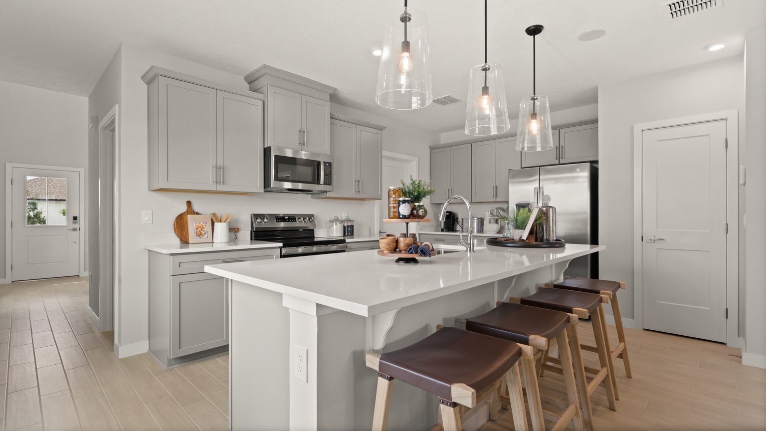 The Jupiter Model Home Kitchen at Grasslands West by DRB Homes