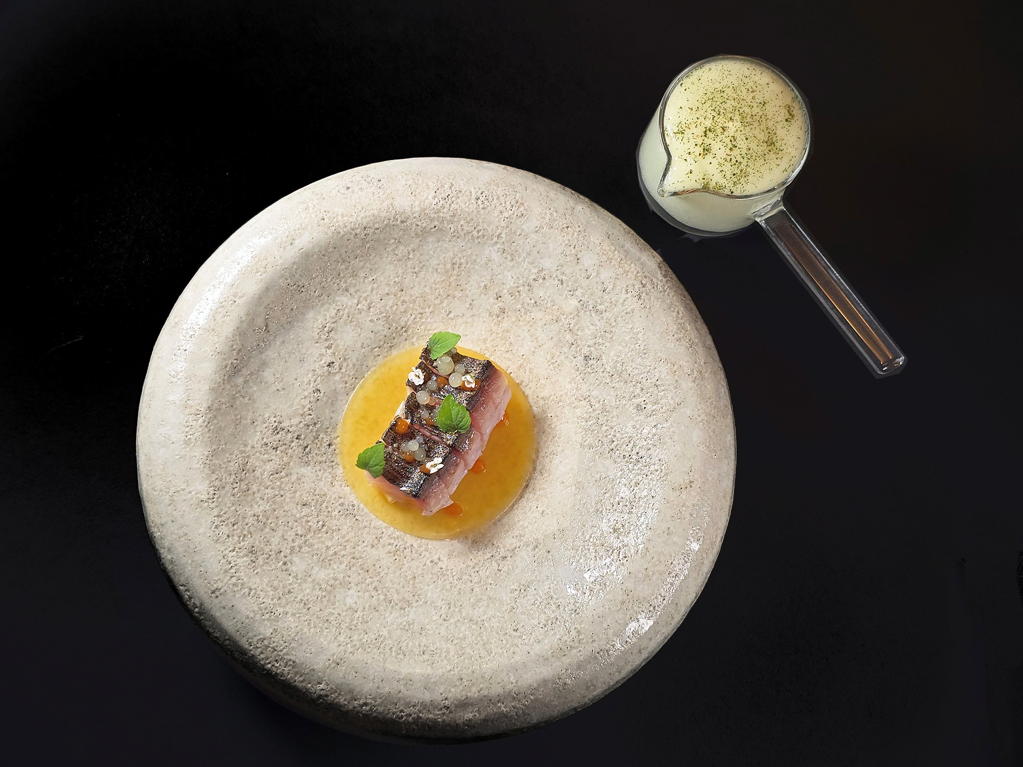 A seafood course at Essential by Christophe. Menus change with the season and by chef inspiration, and are served as a four course Discovery Menu and a seven course Chef's Tasting Menu.