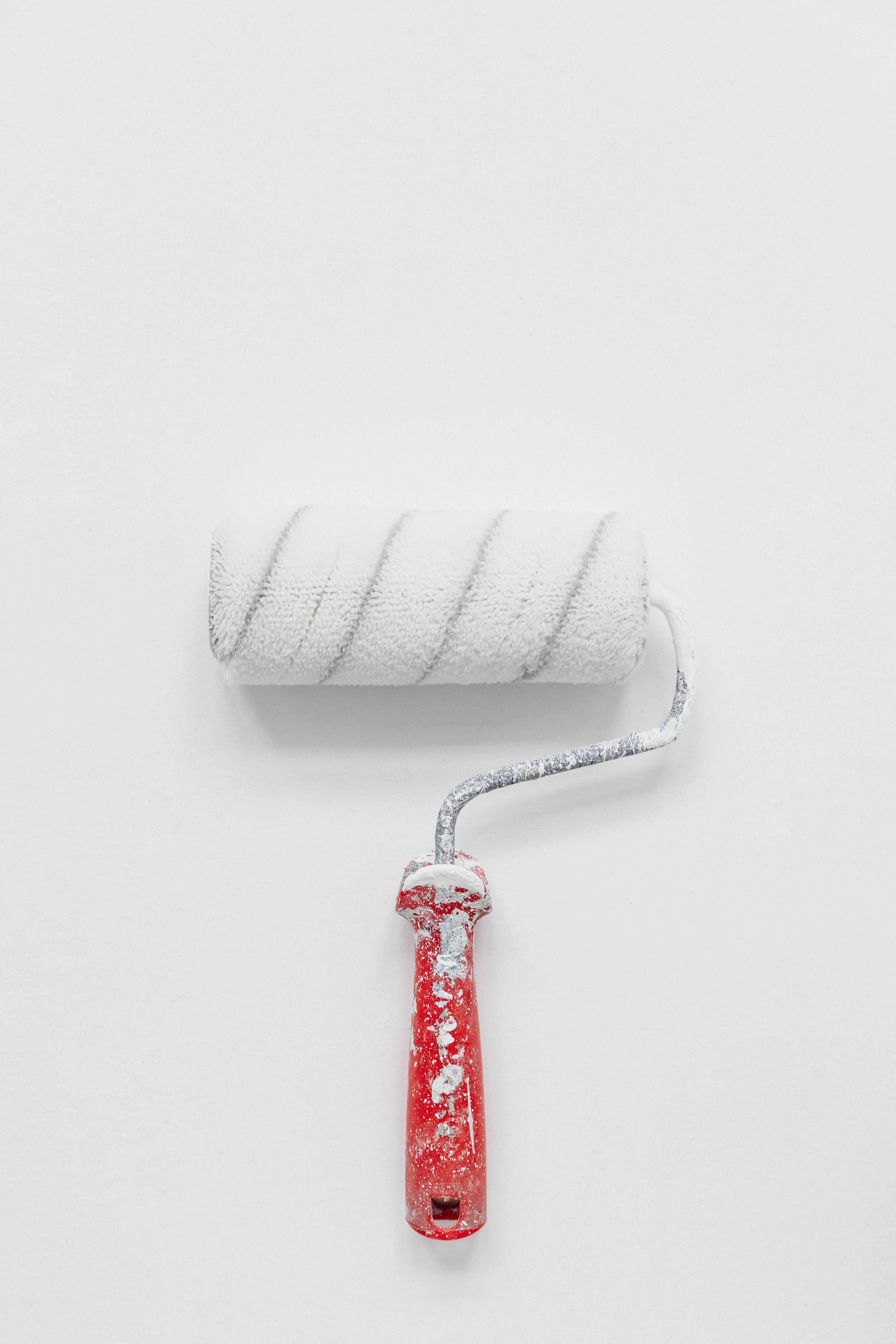 white paintbrush with red handle