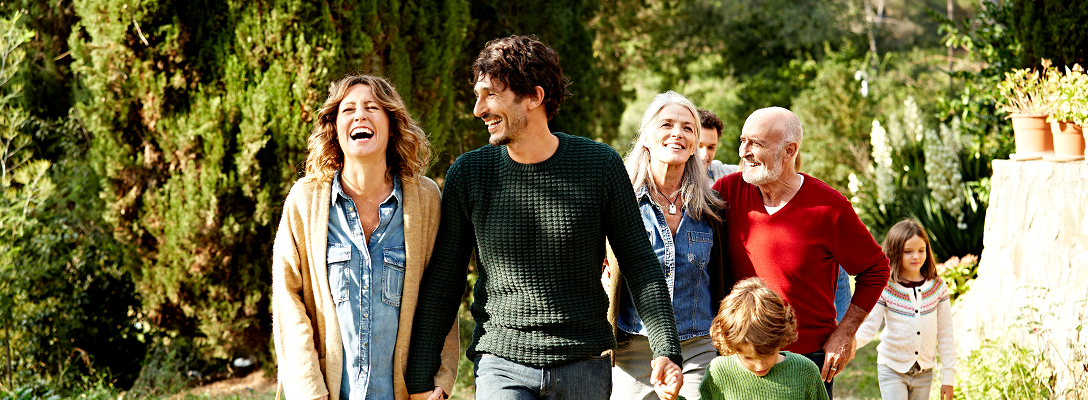 A multigenerational family walking in the yard.