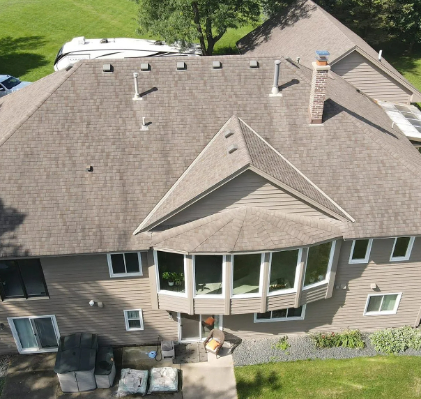 High-angle aerial photo showcasing a comprehensive residential roof replacement with brown architect 