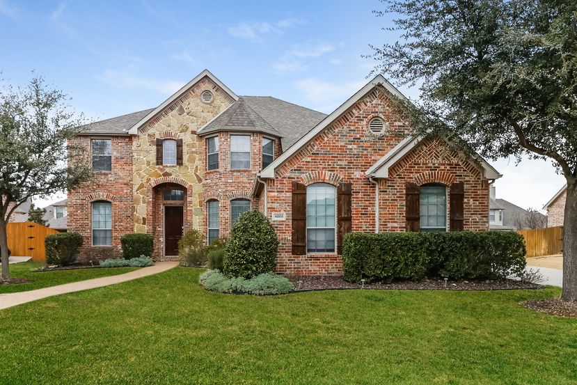 Gorgeous brick home with long walkway at Invitation Homes Houston.