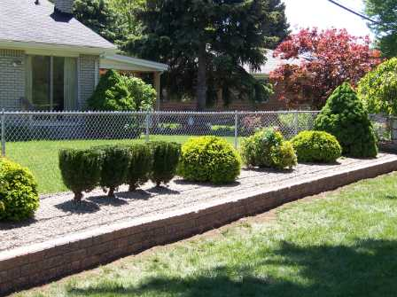 house with landscaping and hardscaping work by M & D Design & Build