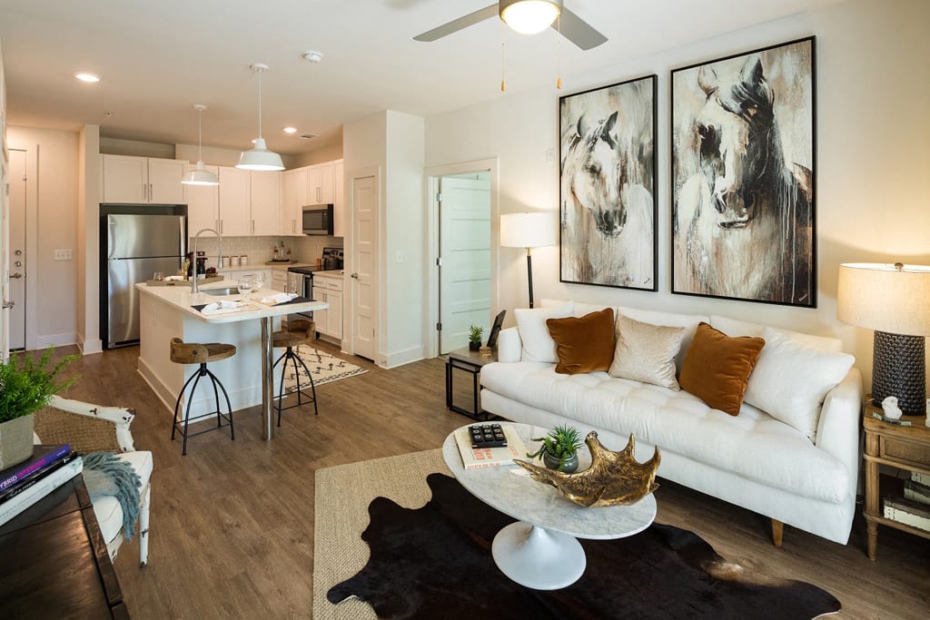 Gorgeous Modern Living Rooms with Barn-Style Lighting and Reclaimed Wood-Inspired Flooring at Echo at North Pointe Center Apartment Homes