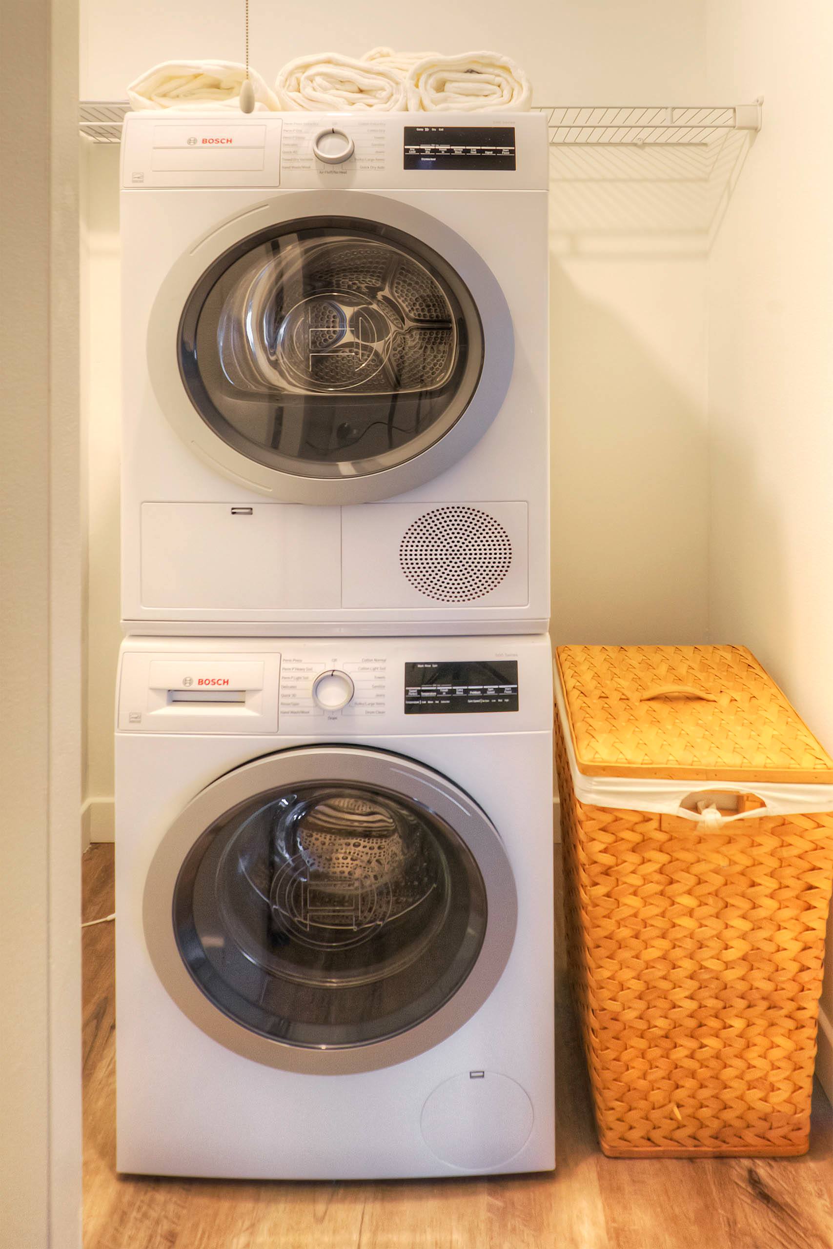 Stacked washer and dryer in laundry closet 