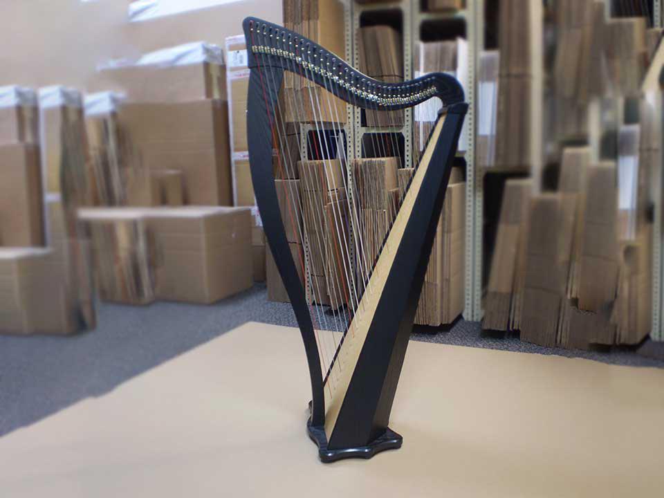 an antique harp standing upright