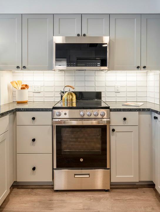 White tile backsplash and matte black hardware and fixtures
