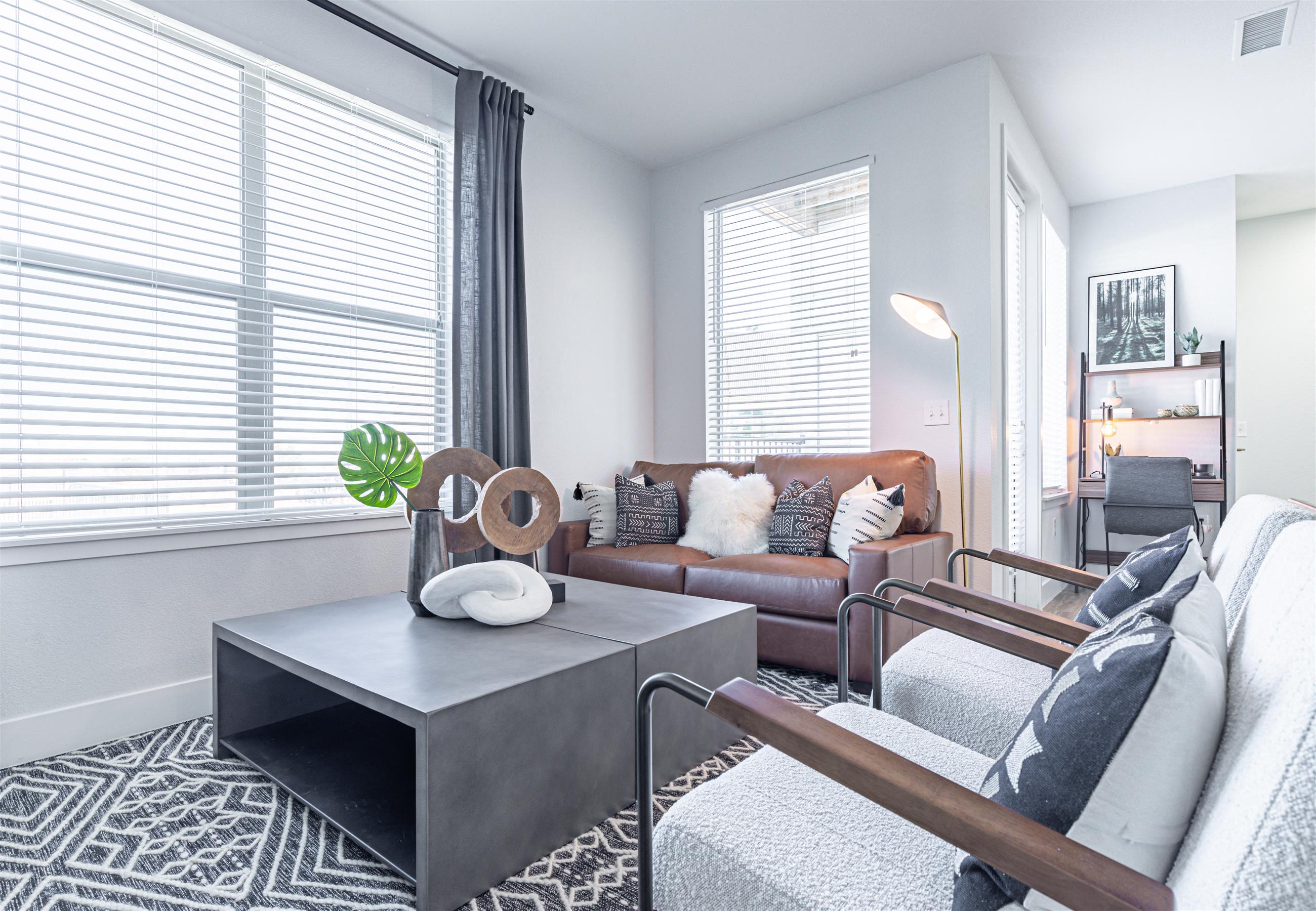 a living room with a leather couch and a coffee table