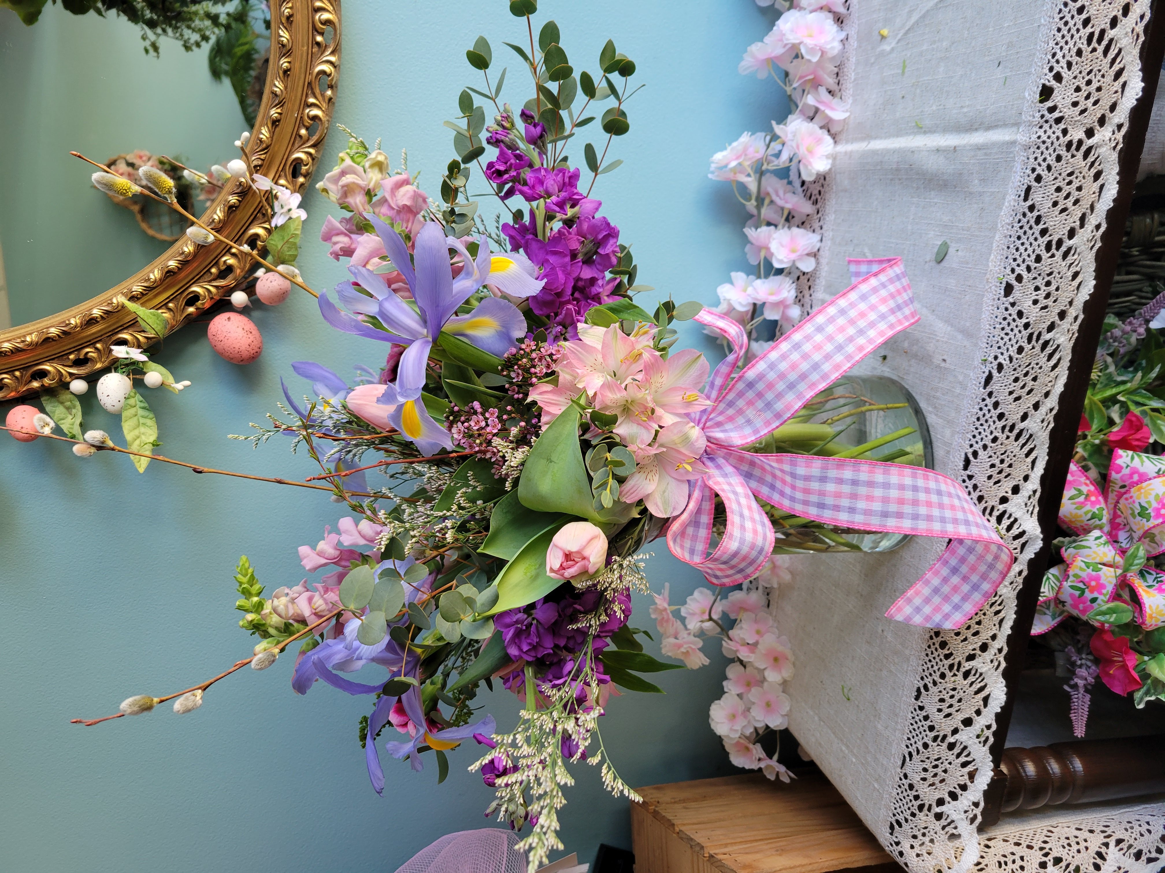 Spring pastels vase arrangement with iris, tulips, alstromeria, stock, snapdragons, and pussy willows.