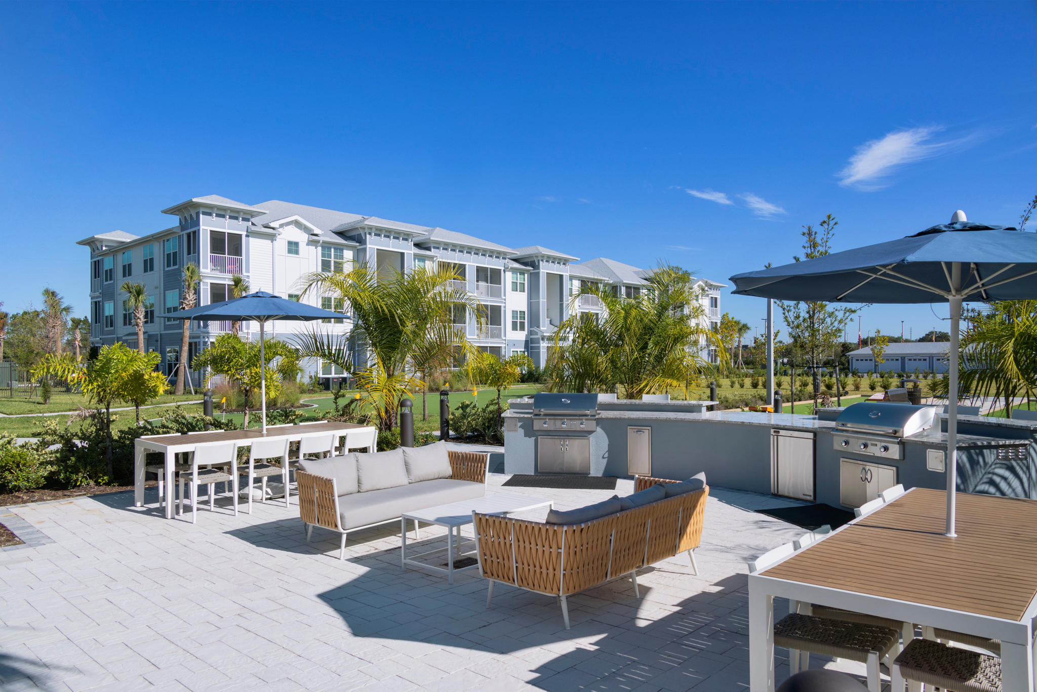 BBQ Grills and Lounge Area at The Gallery at Trinity Luxury Apartments in Trinity, FL