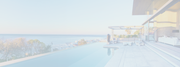 A beautifully designed infinity pool overlooking a calm body of water.