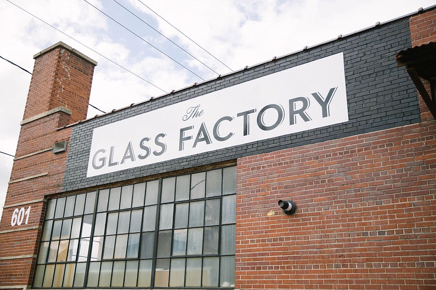 Historic exterior signage at The Glass Factory, an industrial-style wedding and event venue in Jacksonville, Florida.