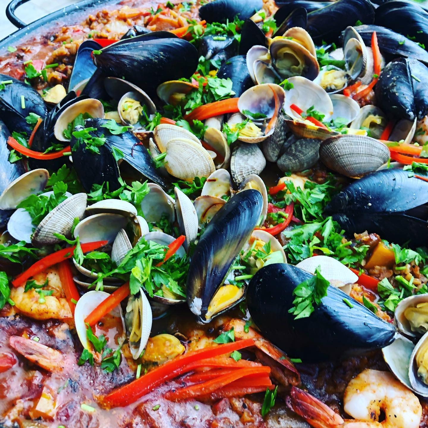 A vibrant and rustic seafood paella prepared by Chef Joe, featuring an abundant mix of fresh mussels, clams, shrimp, and colorful vegetables. Garnished with freshly chopped herbs and sliced red peppers, the dish is layered over a rich and flavorful saffron-infused rice base. This traditional Spanish dish showcases Chef Joe’s ability to create show-stopping, globally inspired meals for events, private dinners, and special occasions throughout Phoenix, Arizona.