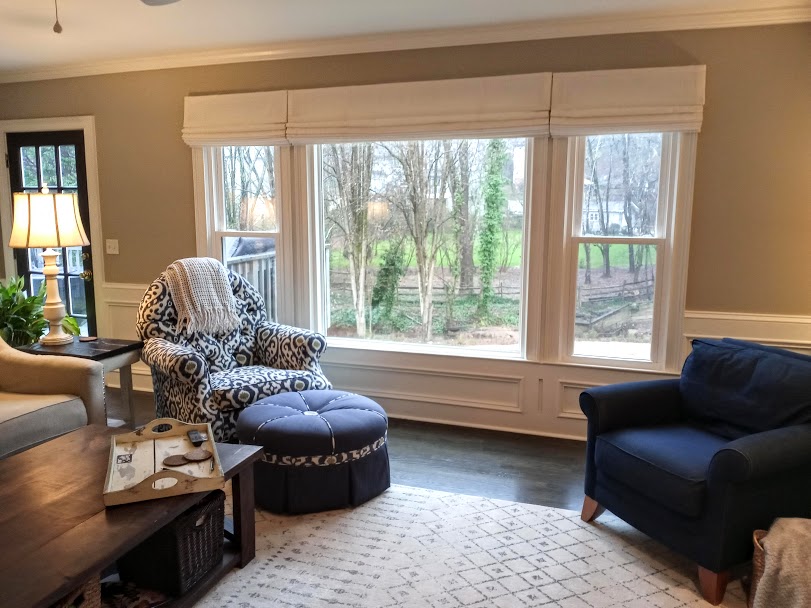 We are loving the beautiful view into the trees from this window. In this case our customer very much wanted to keep their view, so we installed Vadain Roman Shades above the window itself so that when they are fully raised you can appreciate the full view outside the window.