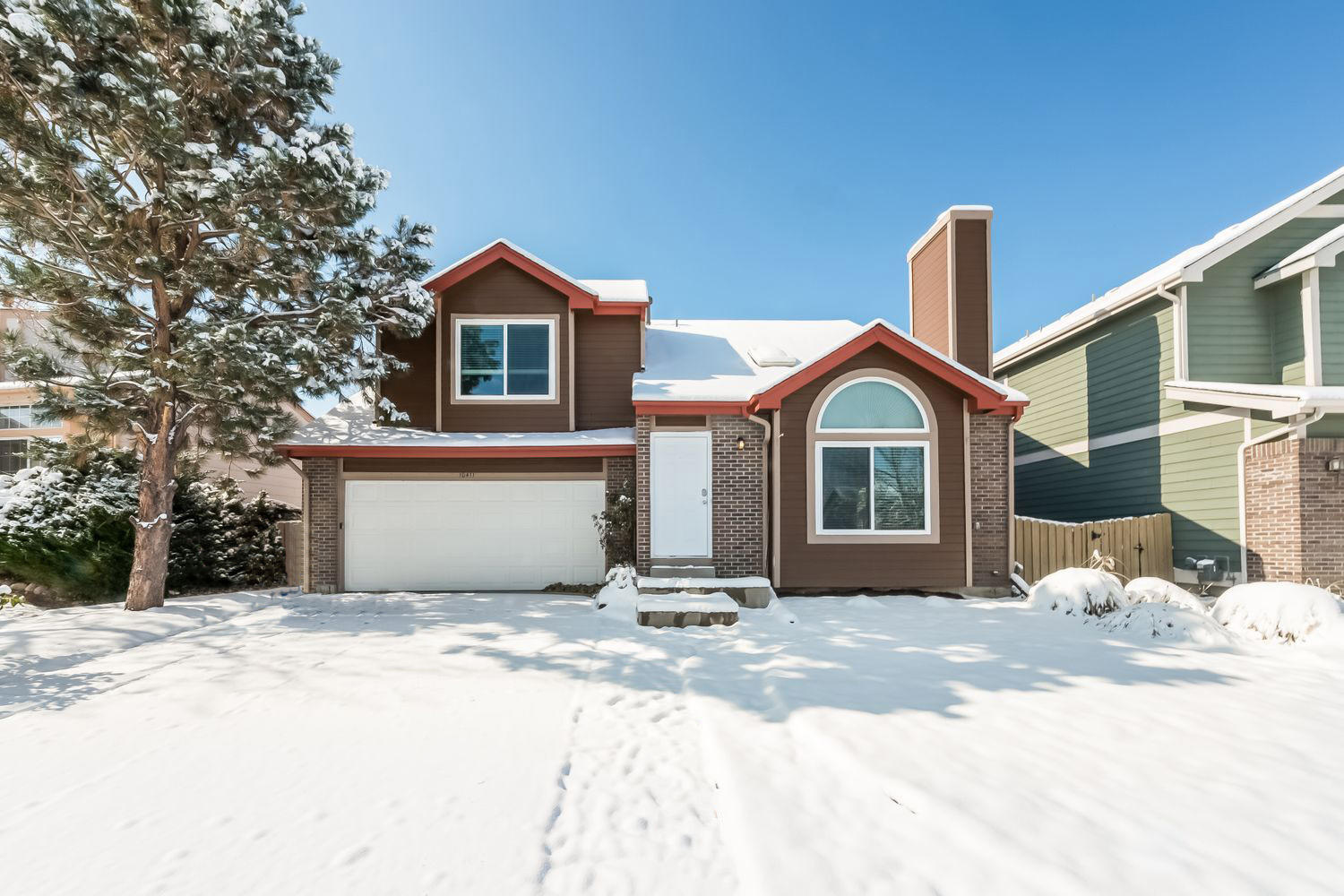 Front of house with large window at Invitation Homes Denver.