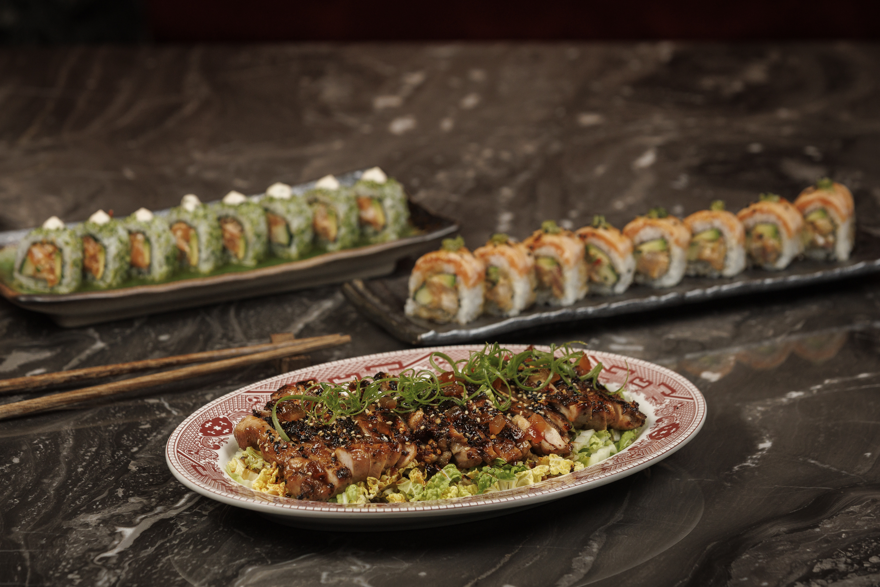 Mr. H signature dishes featuring Smoked Chicken Teriyaki, The Mandarin, and Jade Roll sushi, showcas 