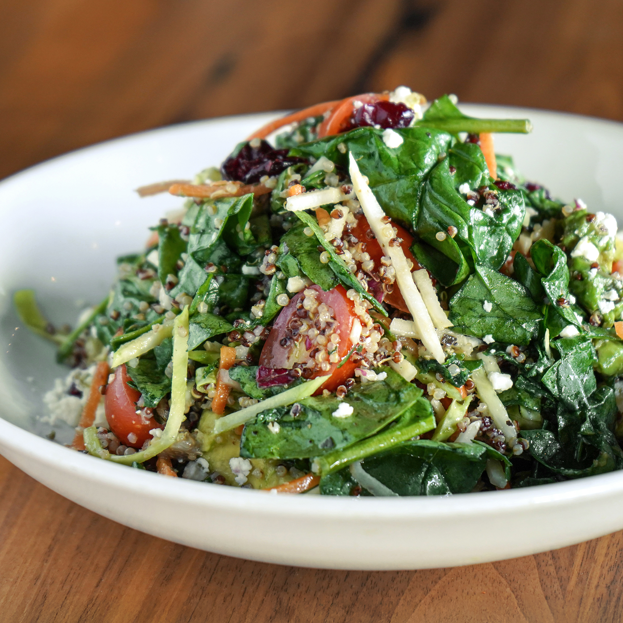 Spinach, avocado, quinoa, grape tomatoes, julienned vegetables, feta, dried cranberries, lemon vinaigrette.