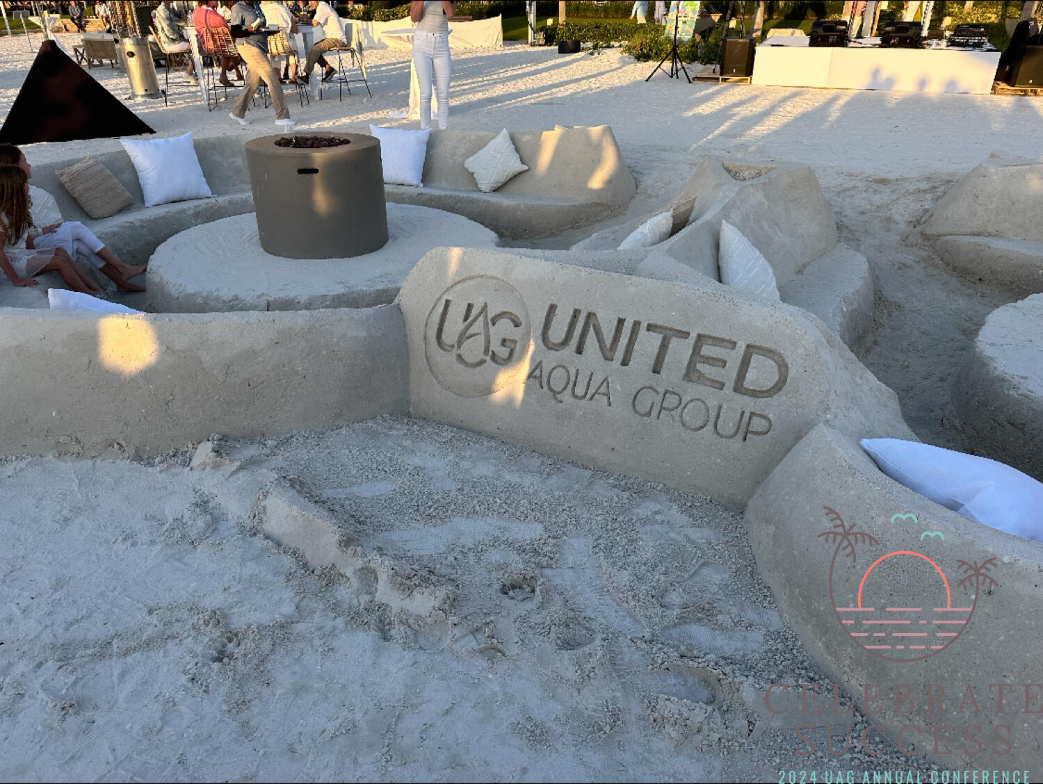 United Aqua Group Logo carved into sand at the 2024 Marco Island Annual Conference.