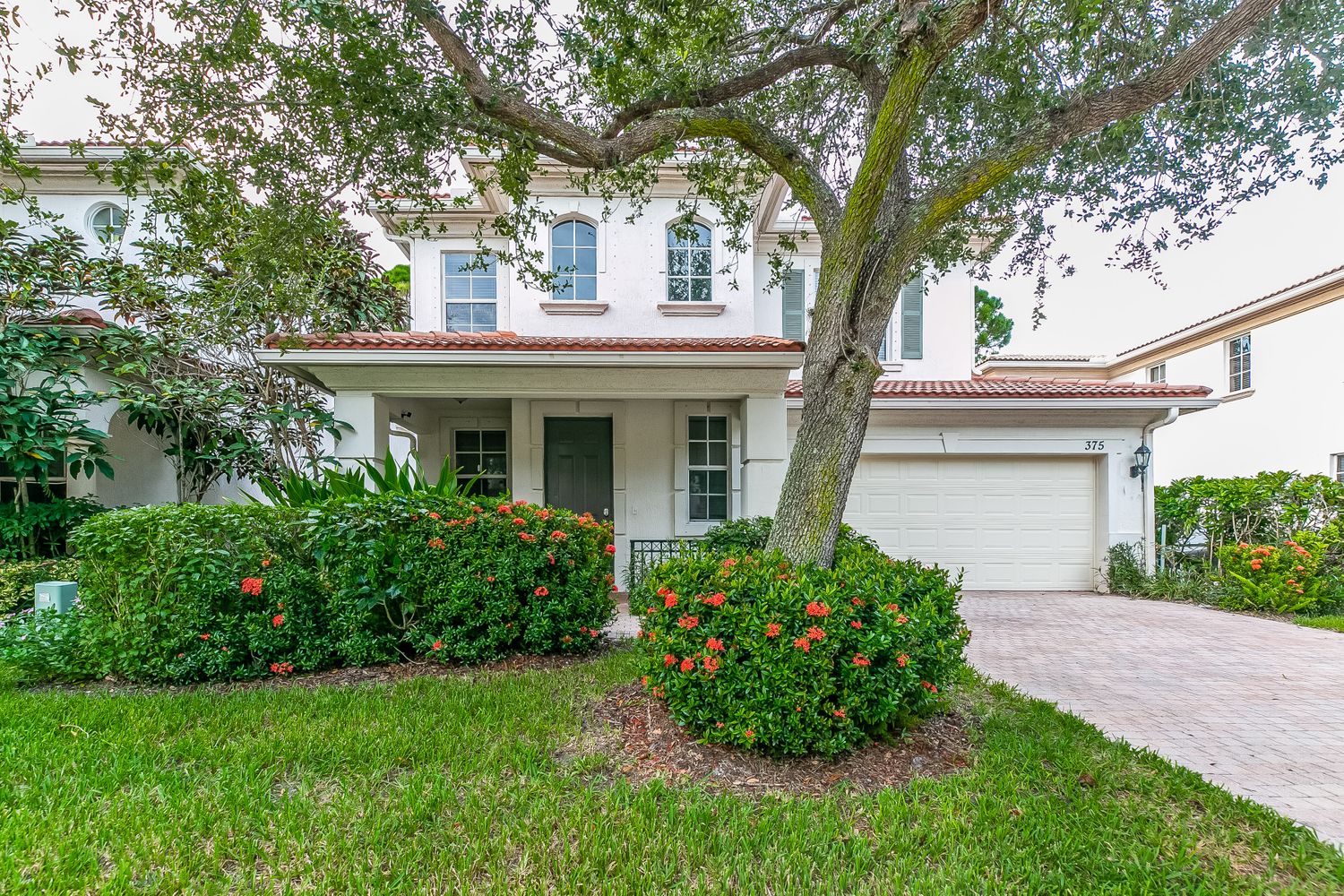 Spacious home with beautiful landscaping and a two-car garage at Invitation Homes South Florida.