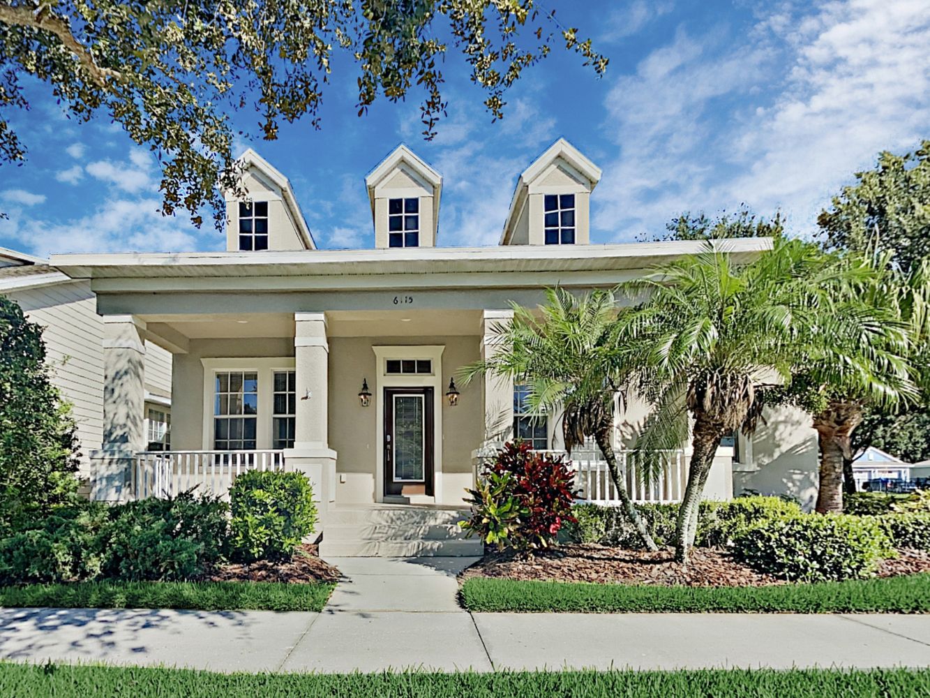 Unique home with a large covered patio at Invitation Homes Tampa.