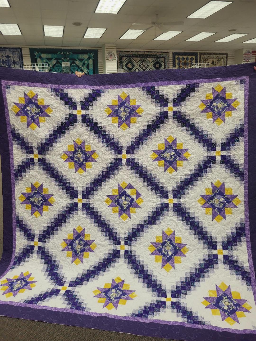 This beautiful quilt with all the purple colors is Ginger's and we quilted it.