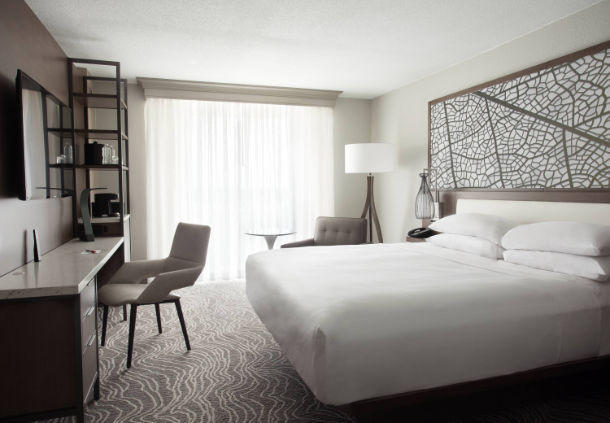 Enjoy natural light through soundproof floor-to-ceiling windows in our spacious king guest room.
