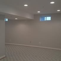 This fully finished basement has new walls, ceiling, recessed lighting, and carpet.