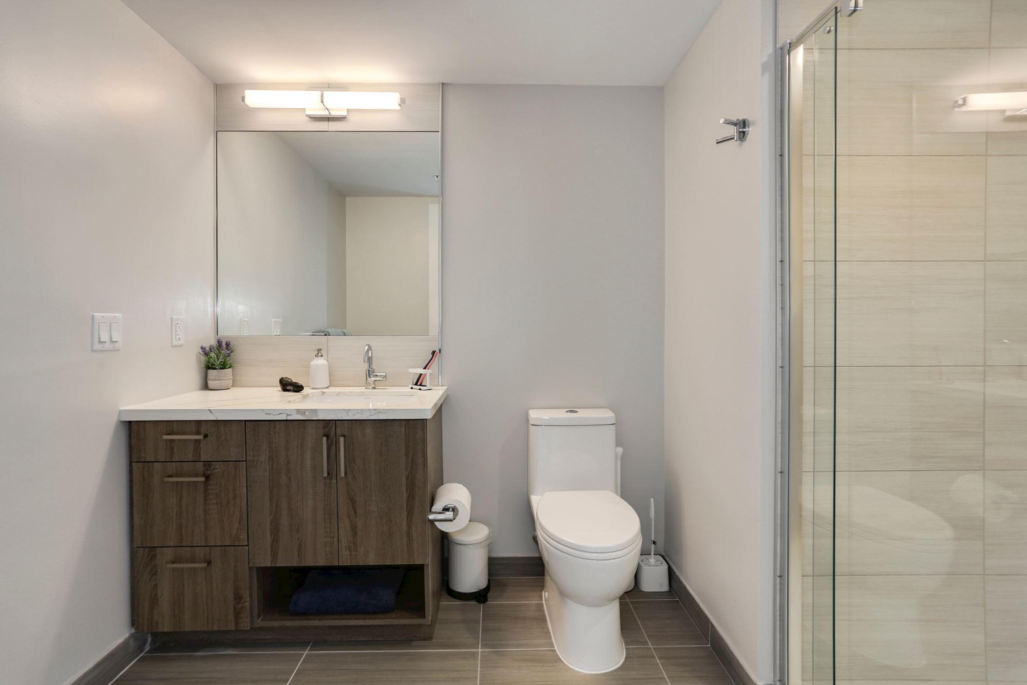 Separate spacious bathrooms with marble vanities