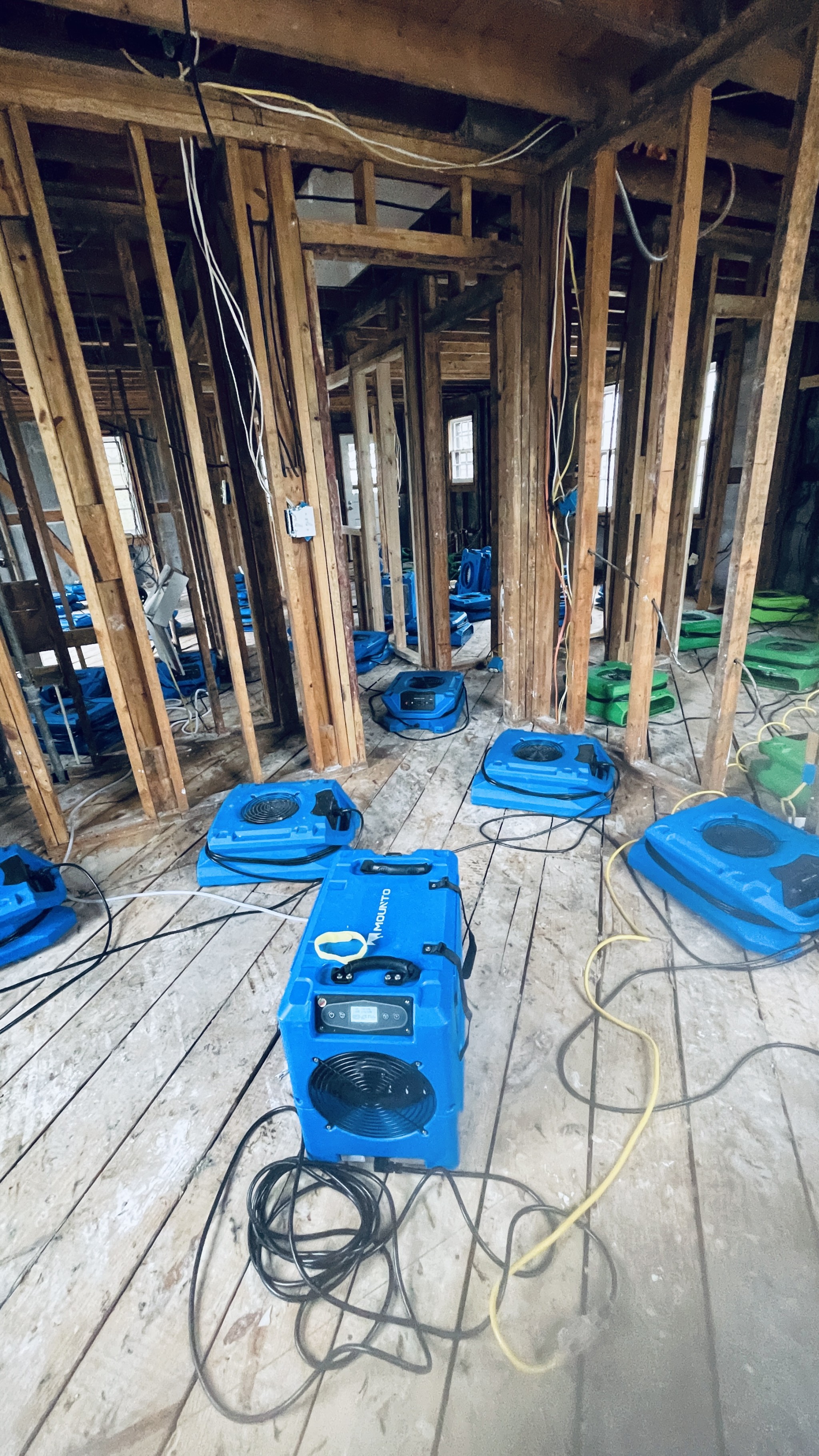 air mover and dehumidifier equipment setup inside after demo at water leak major water damage