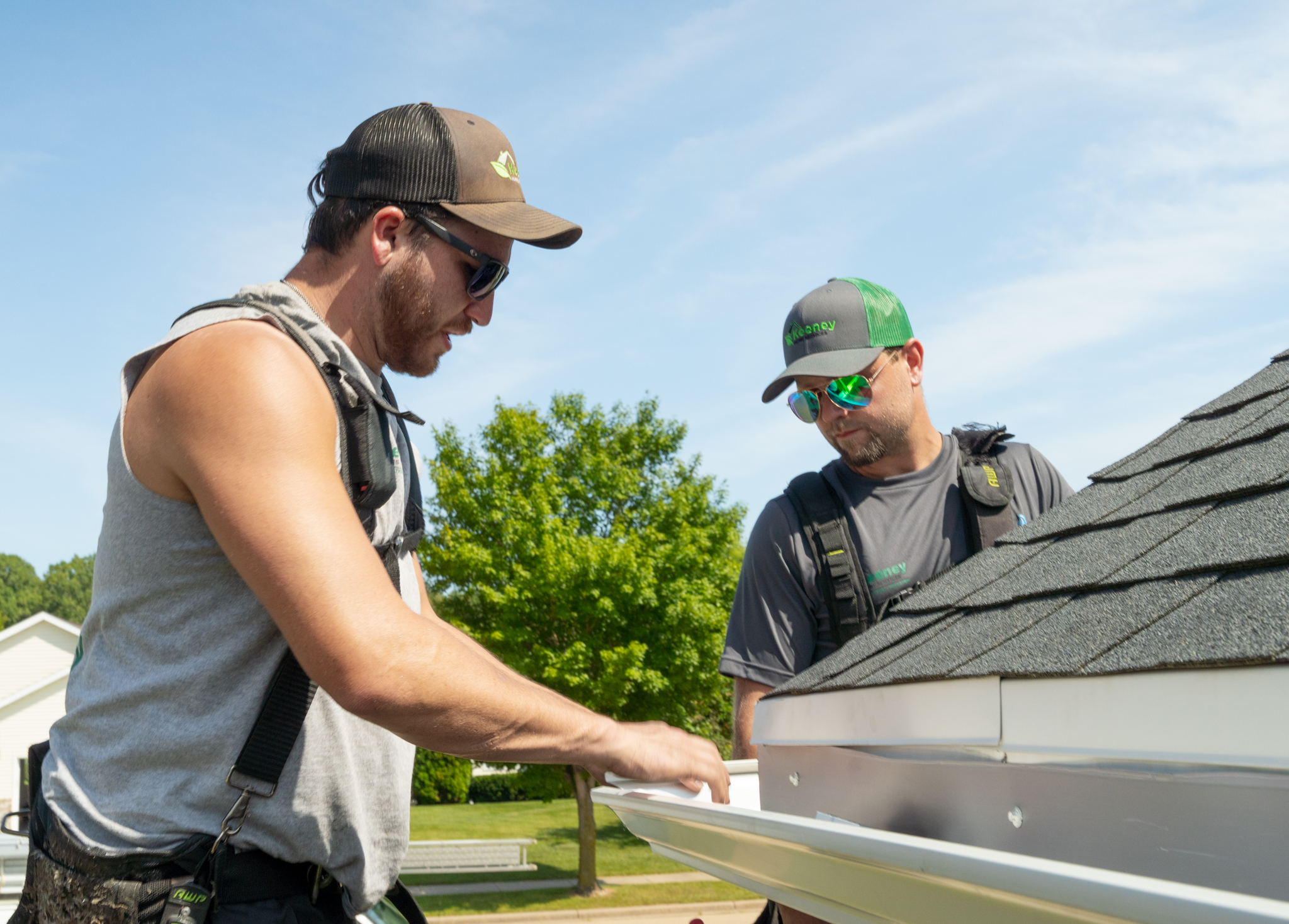 Larson & Keeney Contractors Installing a New Gutter System on a House